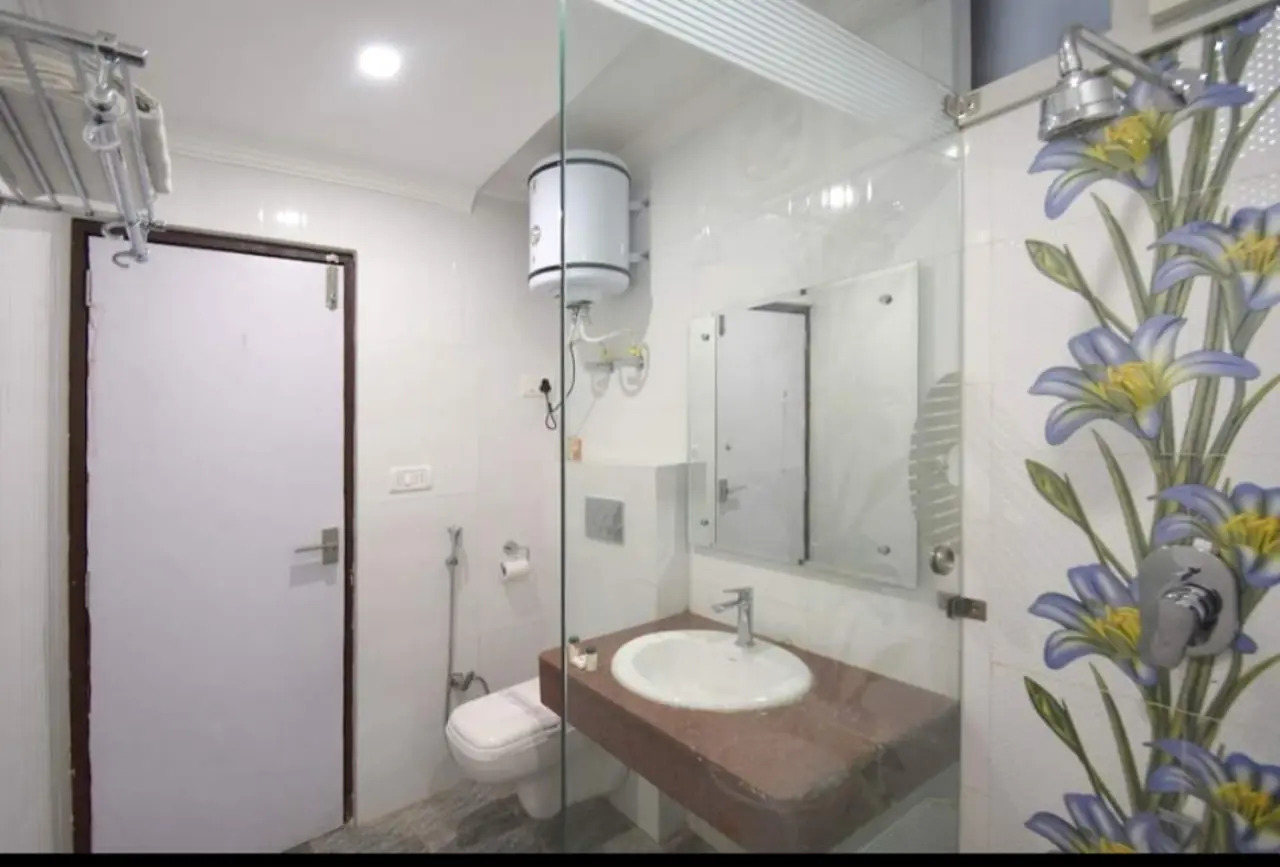 Attached bathroom with hot water geyser in Double Room