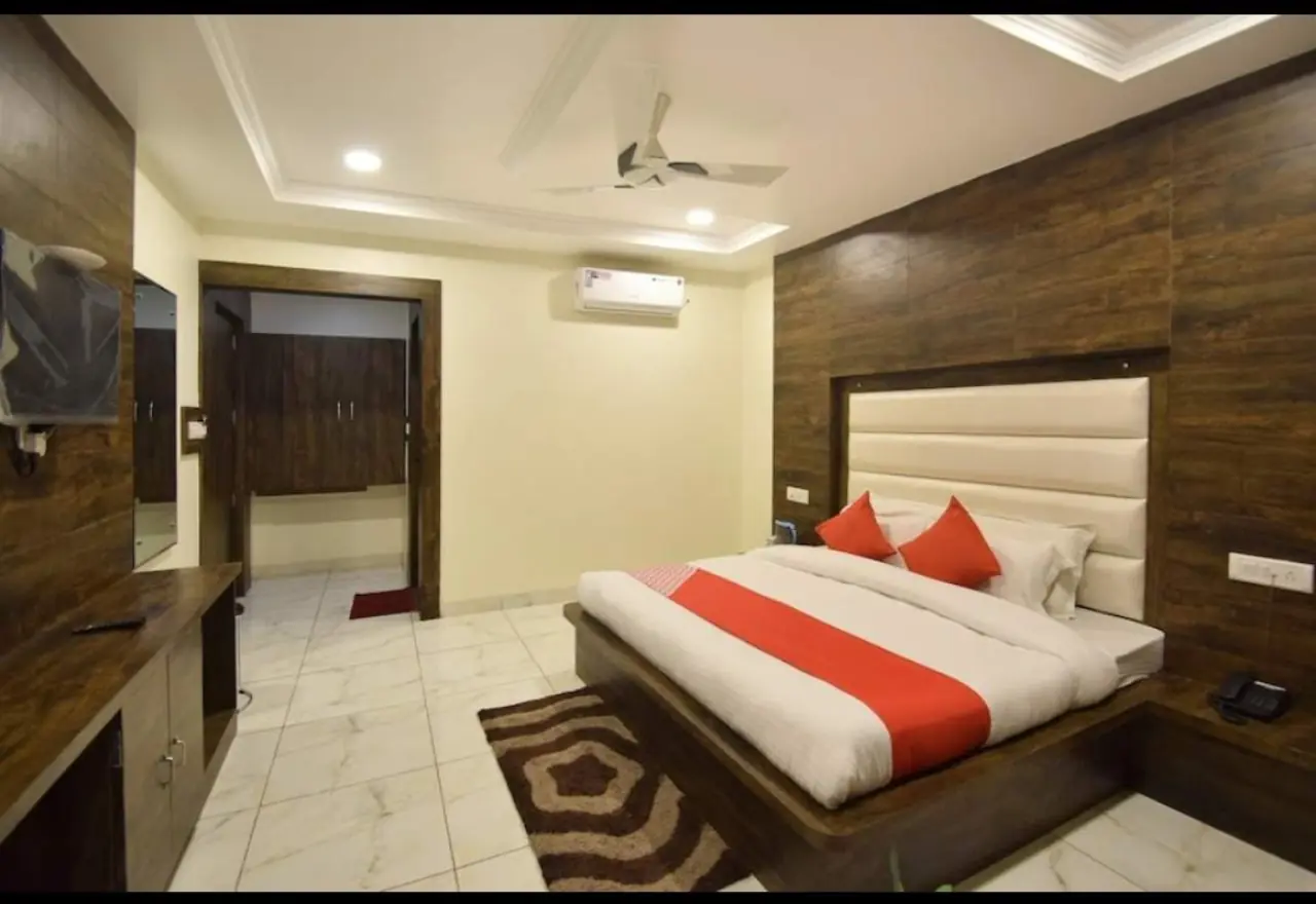 Triple room with warm accent wall at Hotel Galaxy Katra